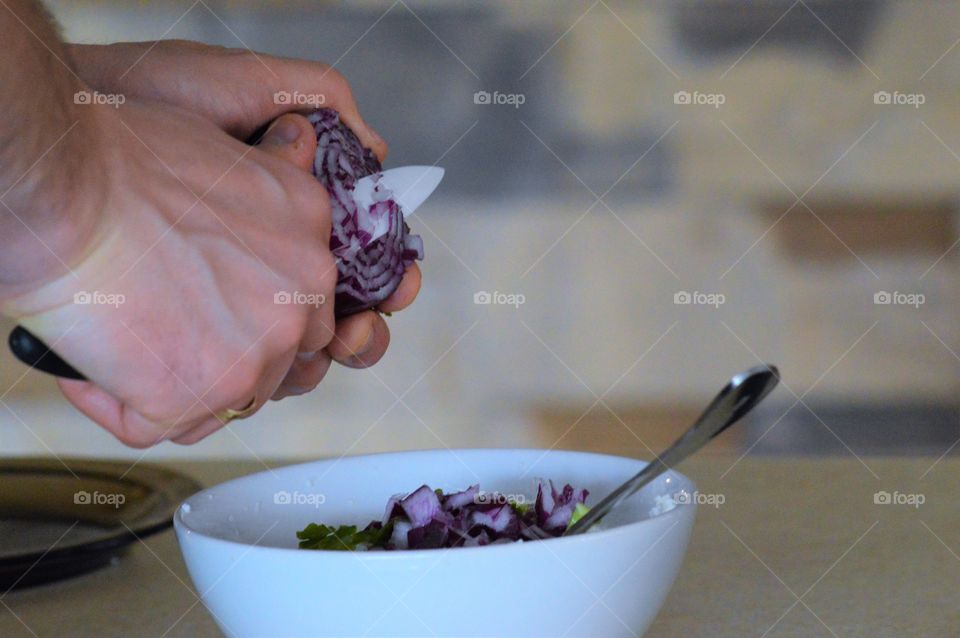 Close-up of a man cutting onion