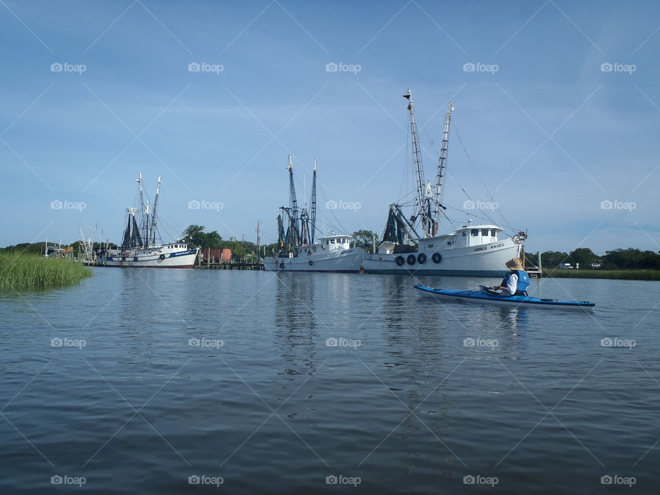 Kayaker and shrimp boats