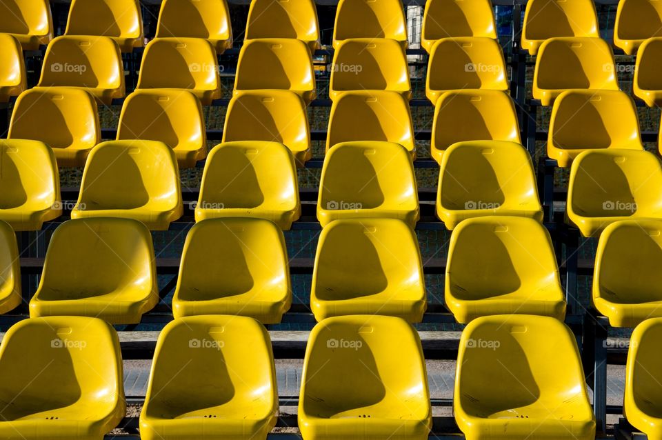 Yellow seats at sunny day