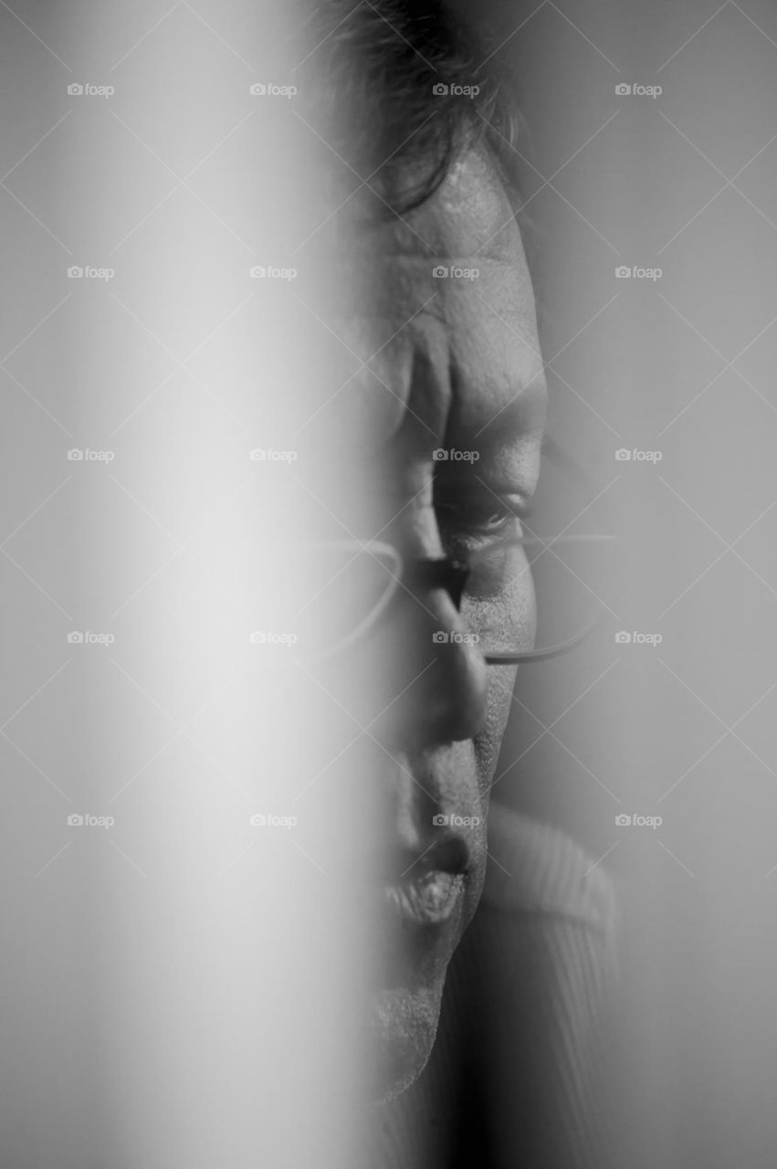 Man seen through a door’s crack 