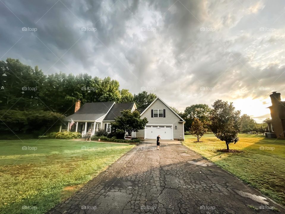 A house at sunset with storm clouds 