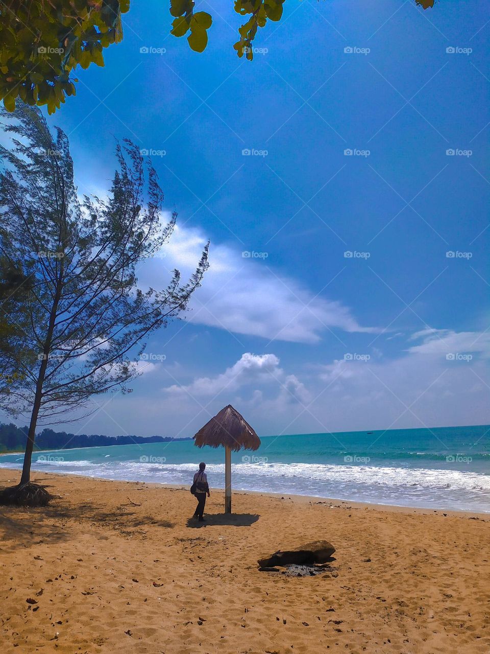 View of white sand and blue sea at Sambas Beach, West Kalimantan, Indonesia.  Taken April 2021