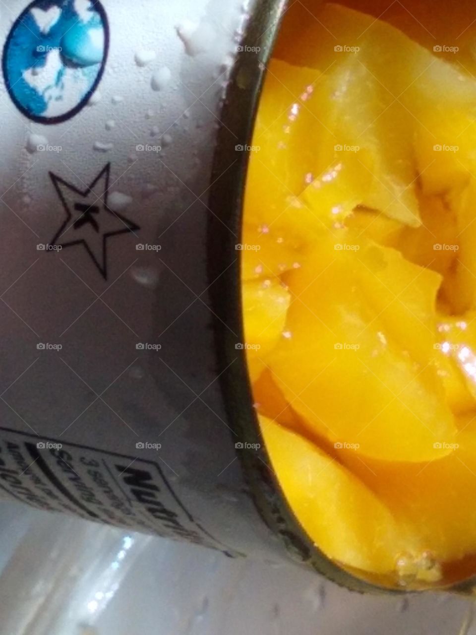 Can that peaches are pouring from up close shot.