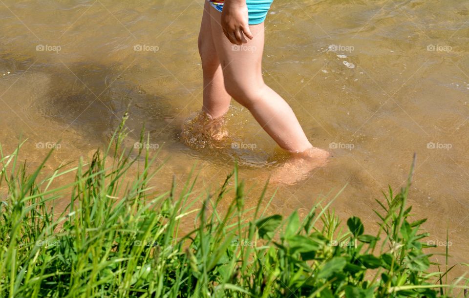 relaxing child in the water lake summer