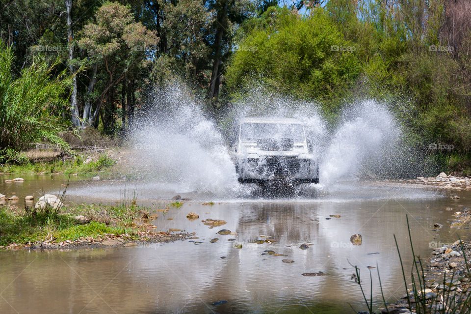 Off road driving through stream.