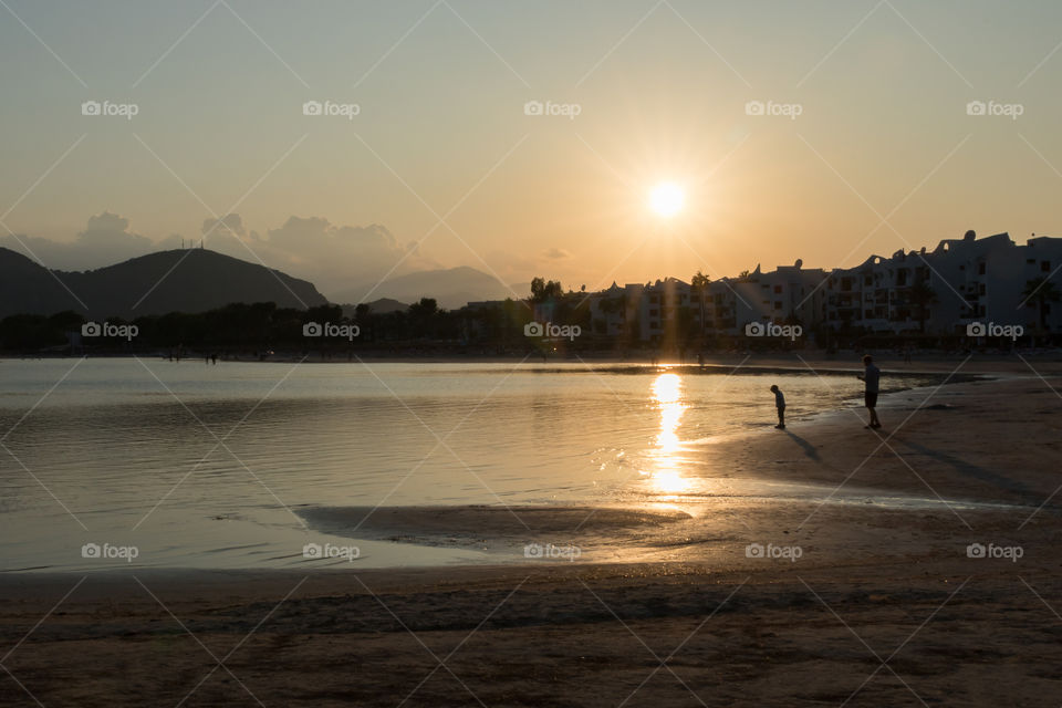 Beautiful sunset at the beach, reflection in the water 