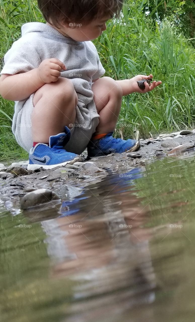 my son playing in the creek