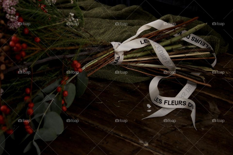 The flowers are laying on a dark table. Who get this flowers for girl? Mysterious admirer, loving husband or unknown stranger?