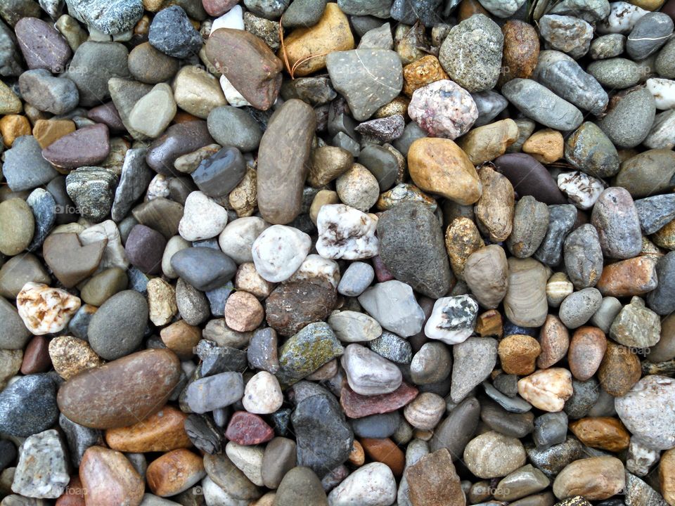 Parking Lot Pebbles. colorful rocks in the parking lot on a rainy day