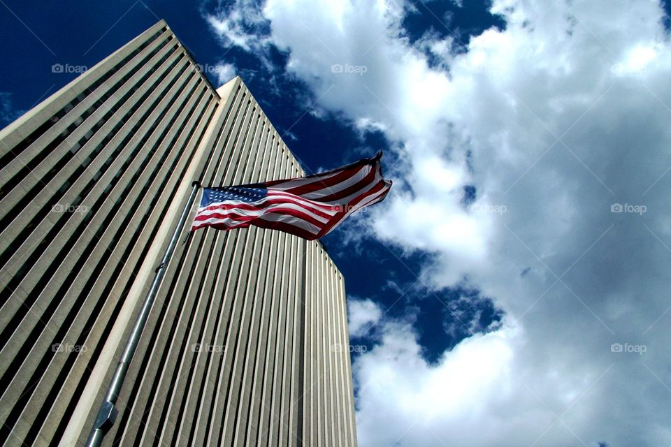 High rise hovering over the USA flag as it blows in the wind
