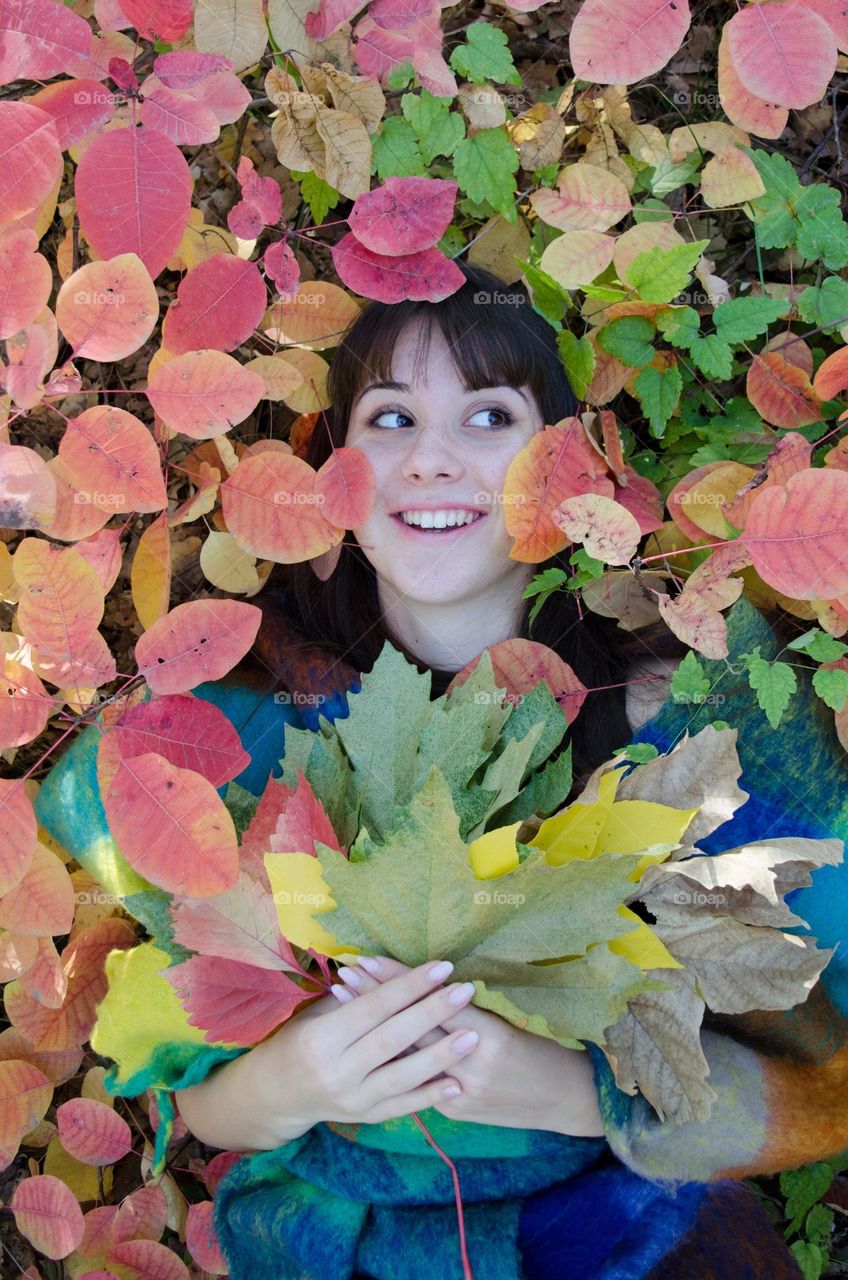 Portrait of a smiling lady on autumn background