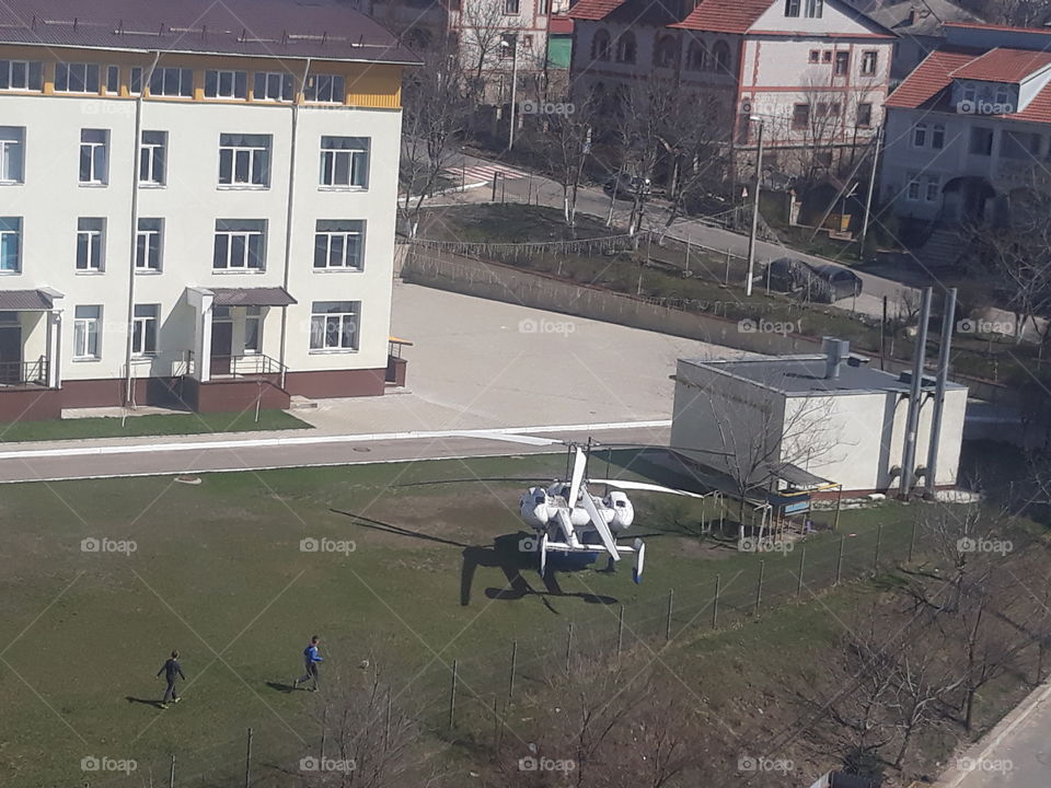 Helicopter on turf at a school