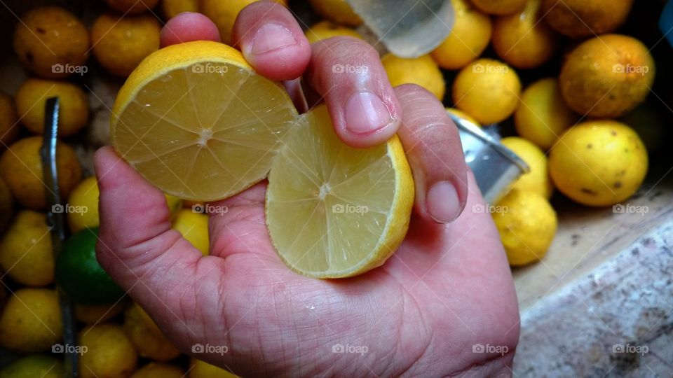 Close-up of women holding lemon