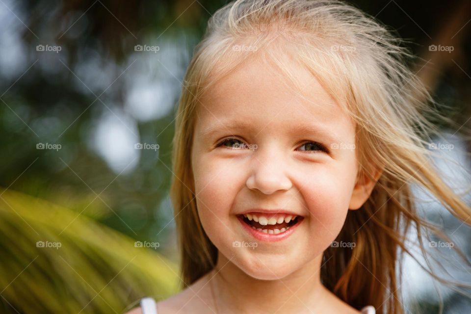 Candid portrait of happy little Caucasian girl outdoor