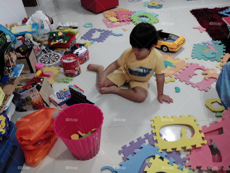 Boy playing at home. messy room