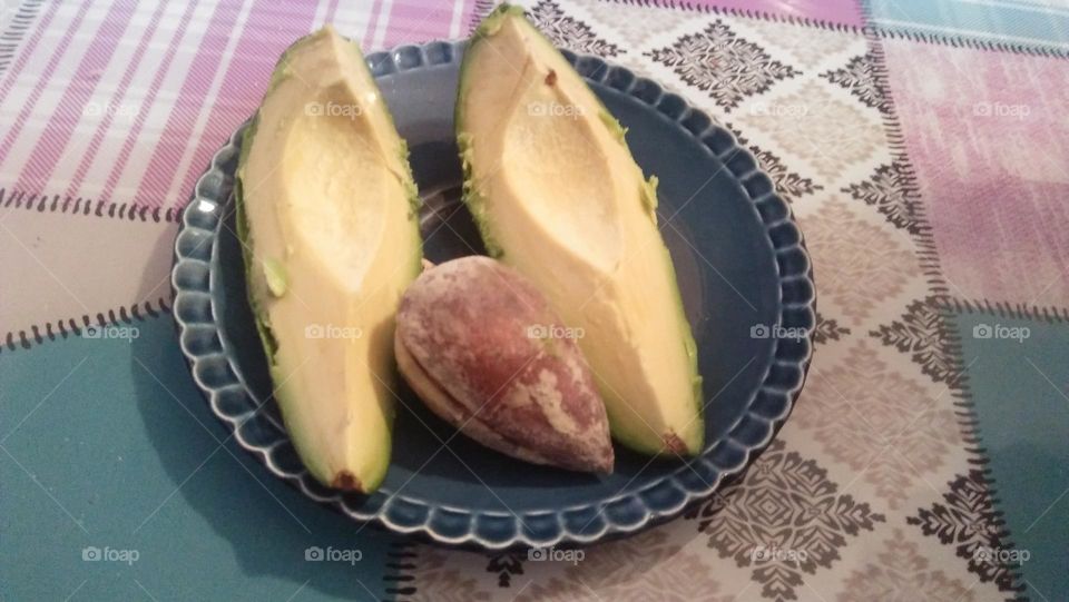 Avocado fruit on plate.