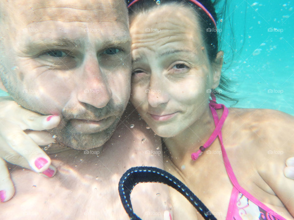 couple underwater. couple having fun underwater