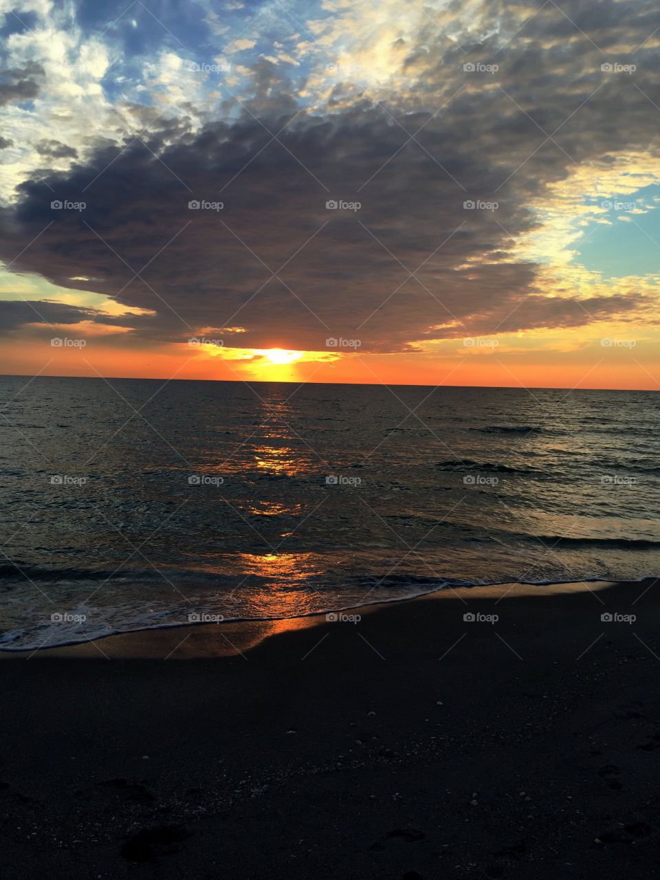 Storm clouds over beach at sunset