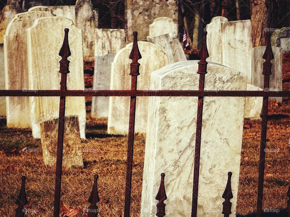 Rusting metal fence at a cemetery 