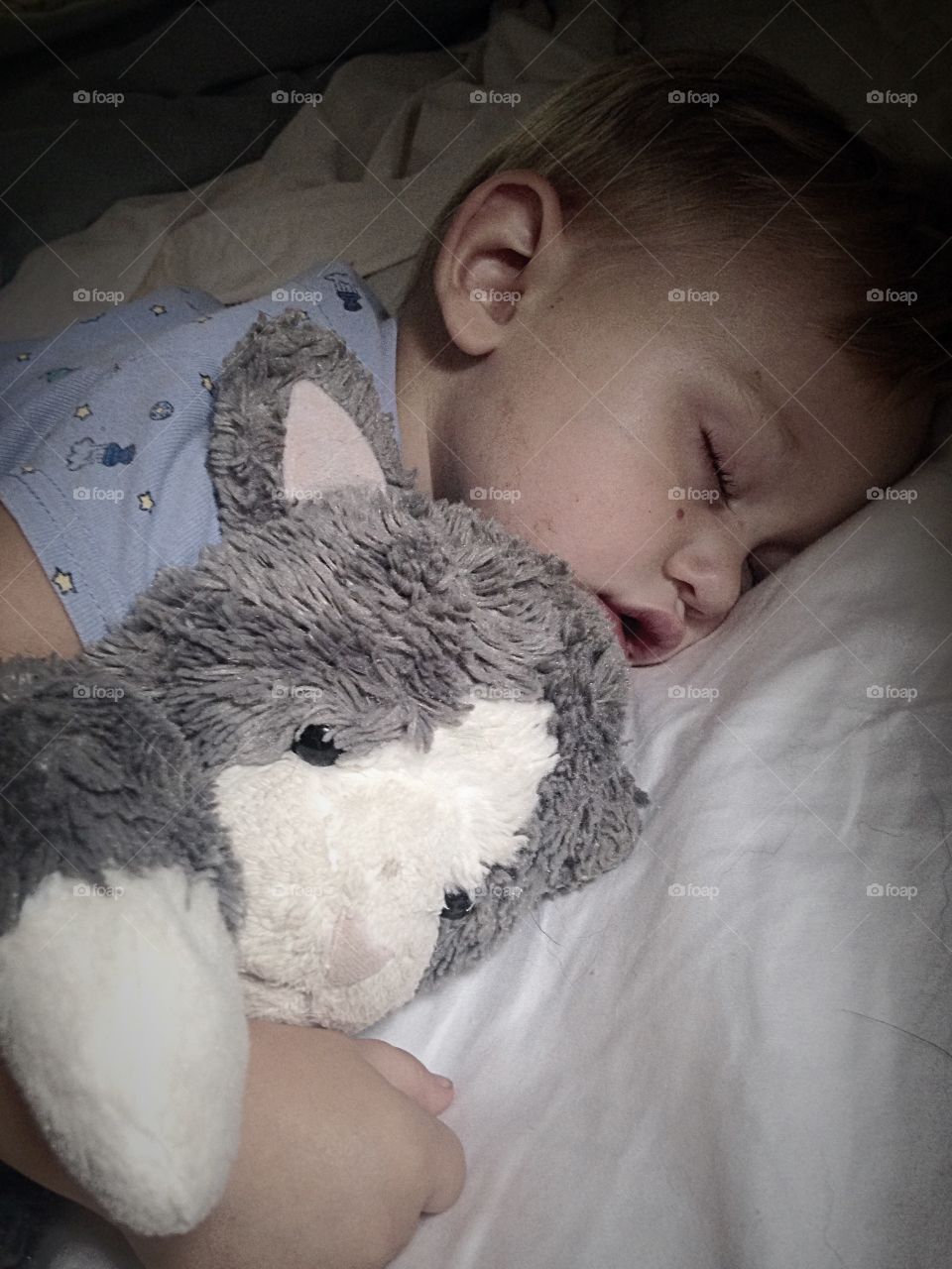 Boy sleeping with his toy