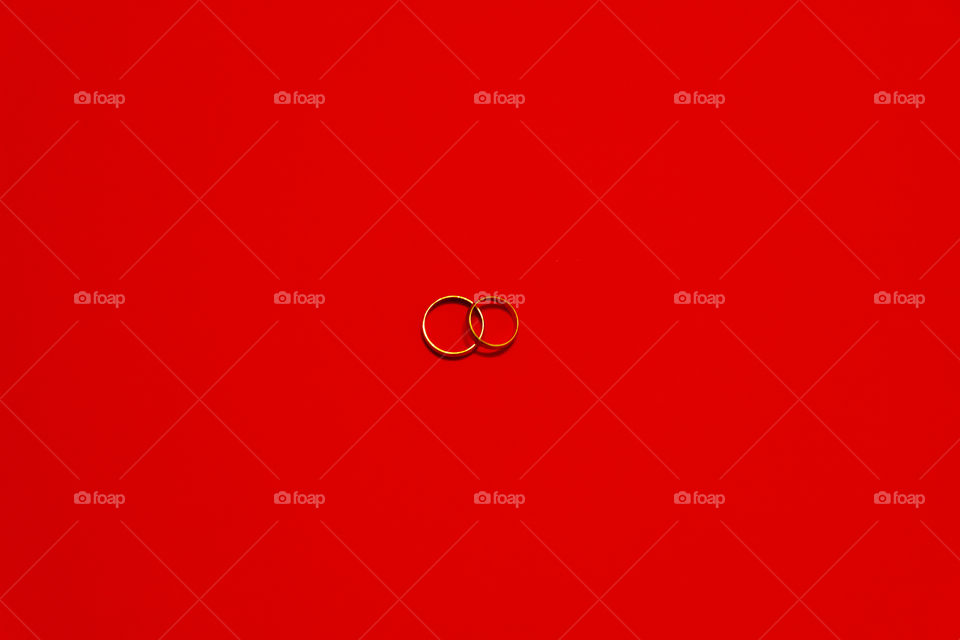 Minimalist - wedding rings on red background