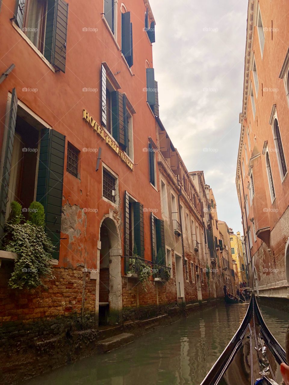 Gondola ride down narrow canals - Venice, Italy