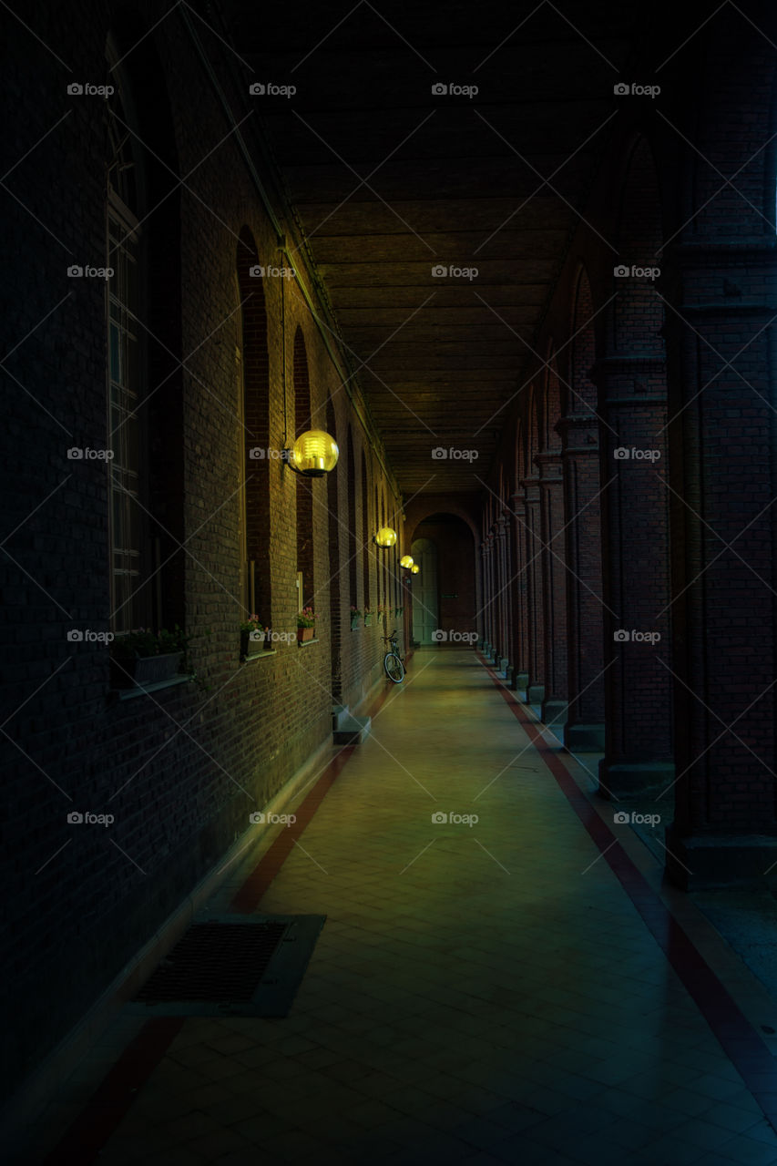 Oldest mental asylum corridor in Gent, Belgium at moonlight and artificial light