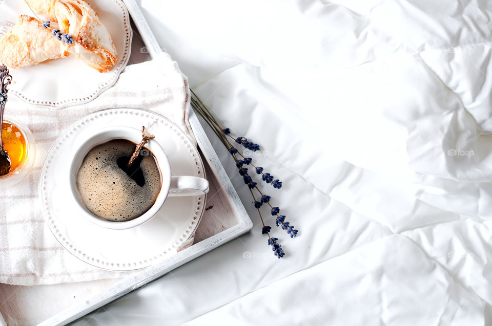 Cup of coffee on bed