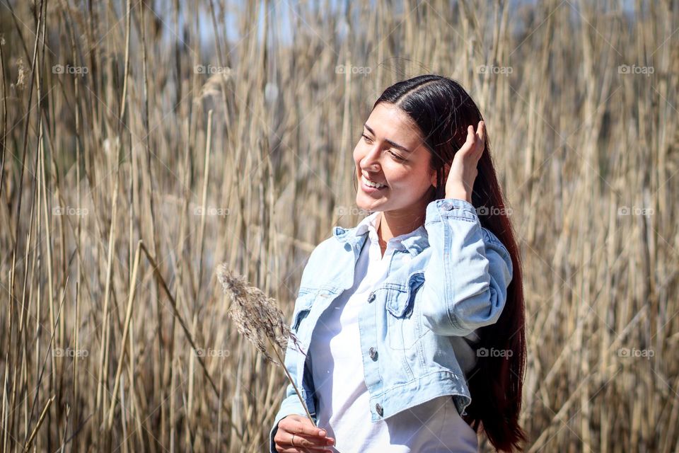 Smiling pretty young woman in a stylish  demi-seasonal outfit