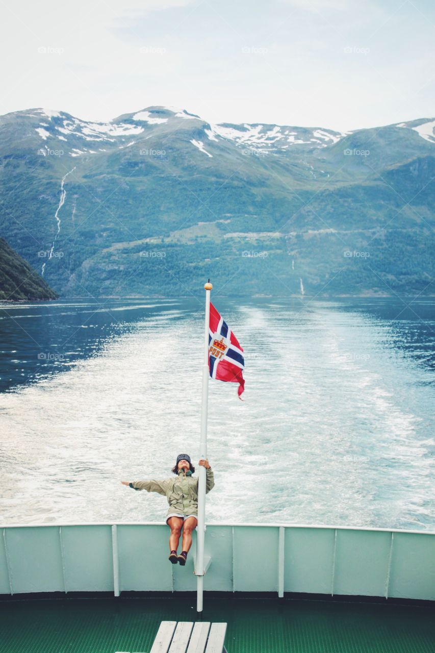 Travel, be brave and catch each unique second of this precious life and our beautiful world! Young woman on the ferry enjoying the cruise and speed of ride.