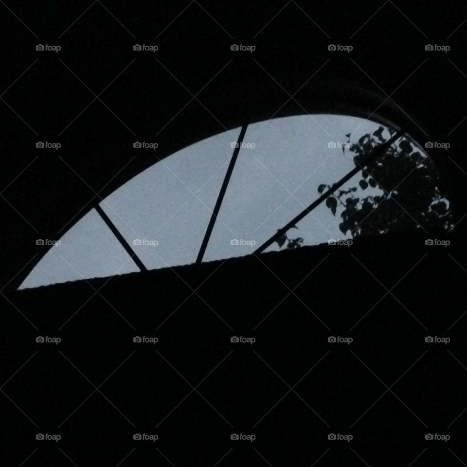 Nighttime, laying in bed looking up at my window during a thunderstorm 