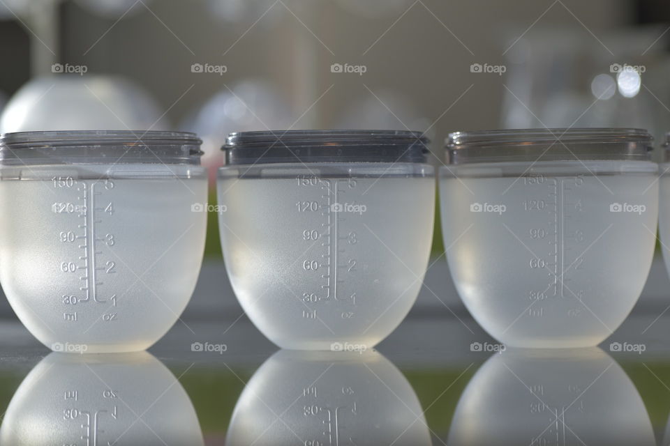 Empty baby bottles on the table with a reflection