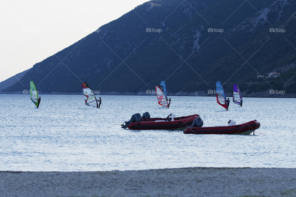 Many windsurfers sailing at sunset in Vassiliki, Lefkada