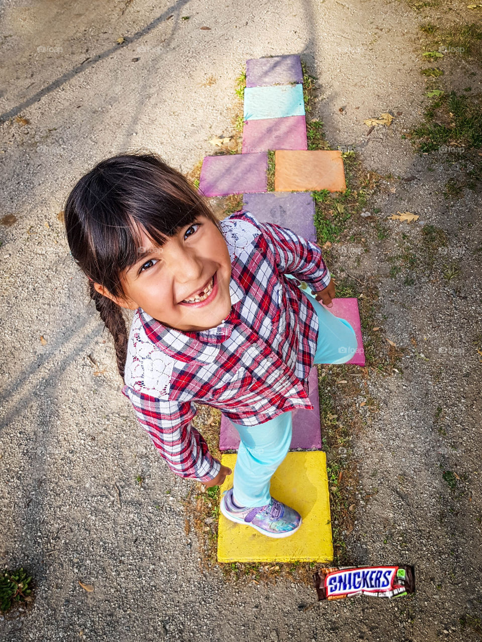 Happy little girl on a hopscotch