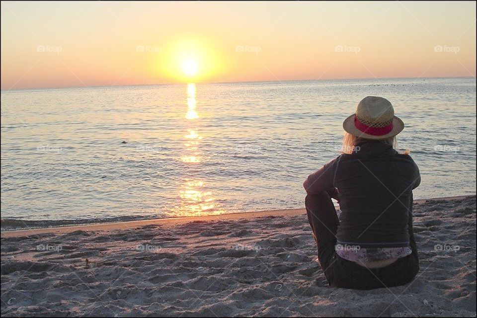 Lady watching the sun set. Lady watching the sun set