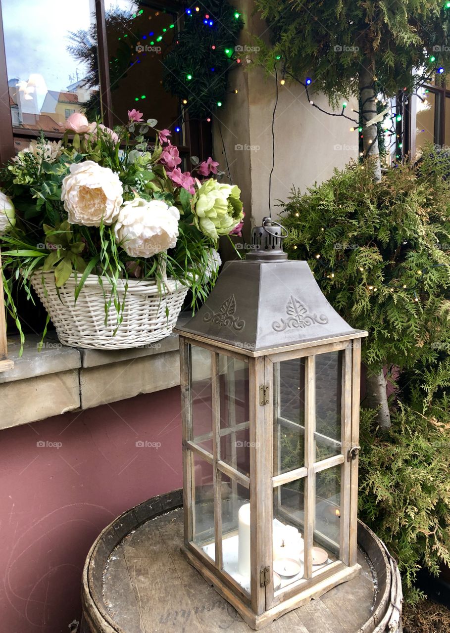 The candle and flower basket as a window decoration 