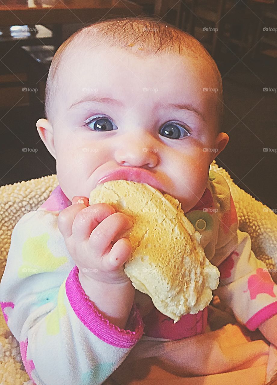 Close-up of a baby girl eating food