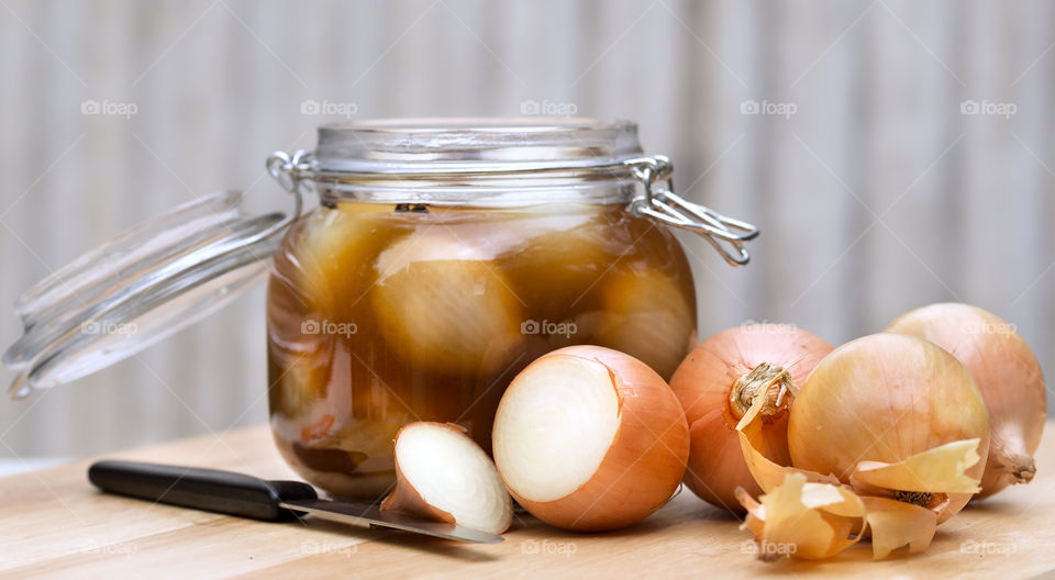 Close-up of onion pickled with kinfe