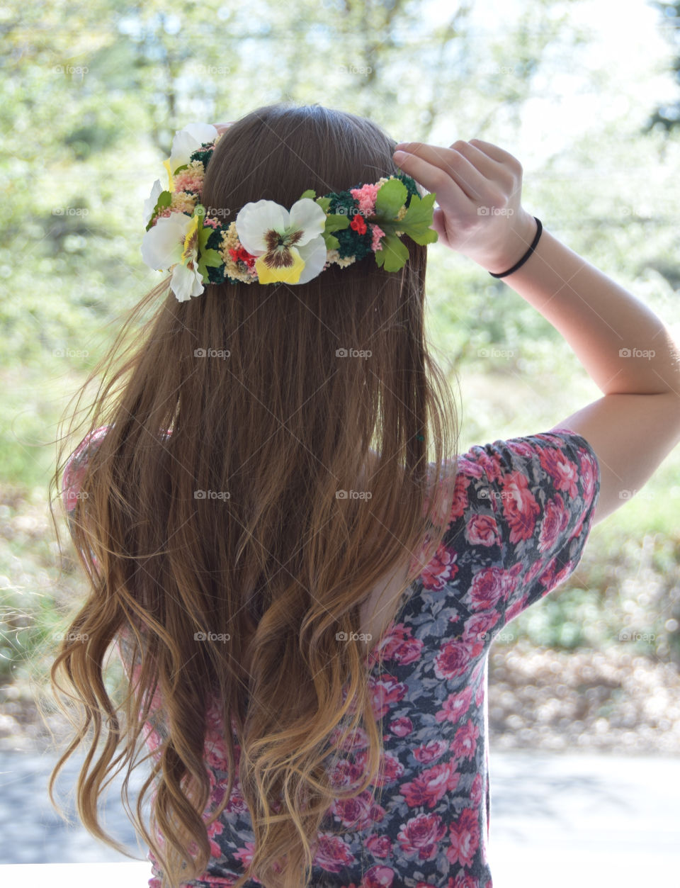 Young brunette woman, floral crown, outdoors