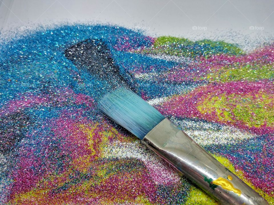 Paintbrush in sea of glitter