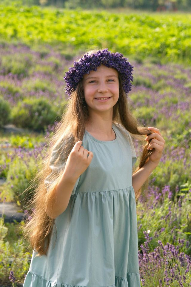 Young girl with long hair wearing a wreath of lavender