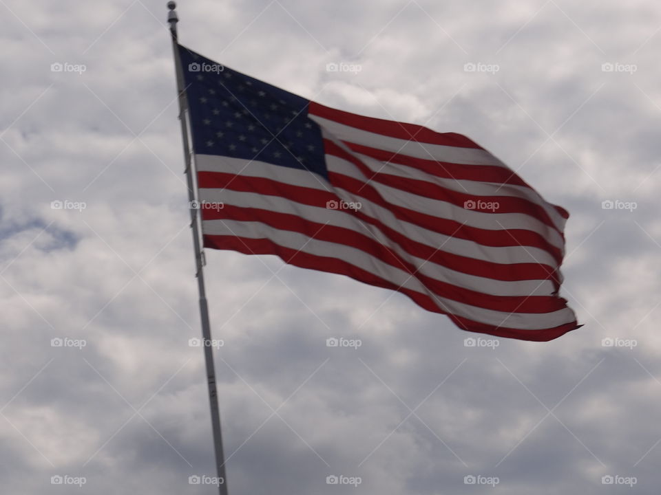 American Flag in Cloudy Sky