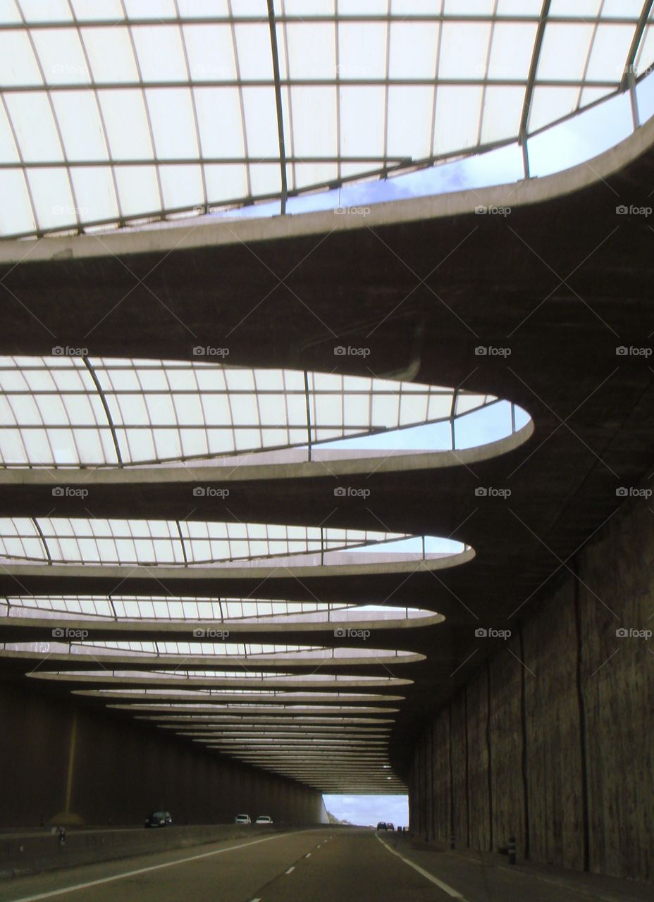 a dark tunnel with big windows in the ceiling