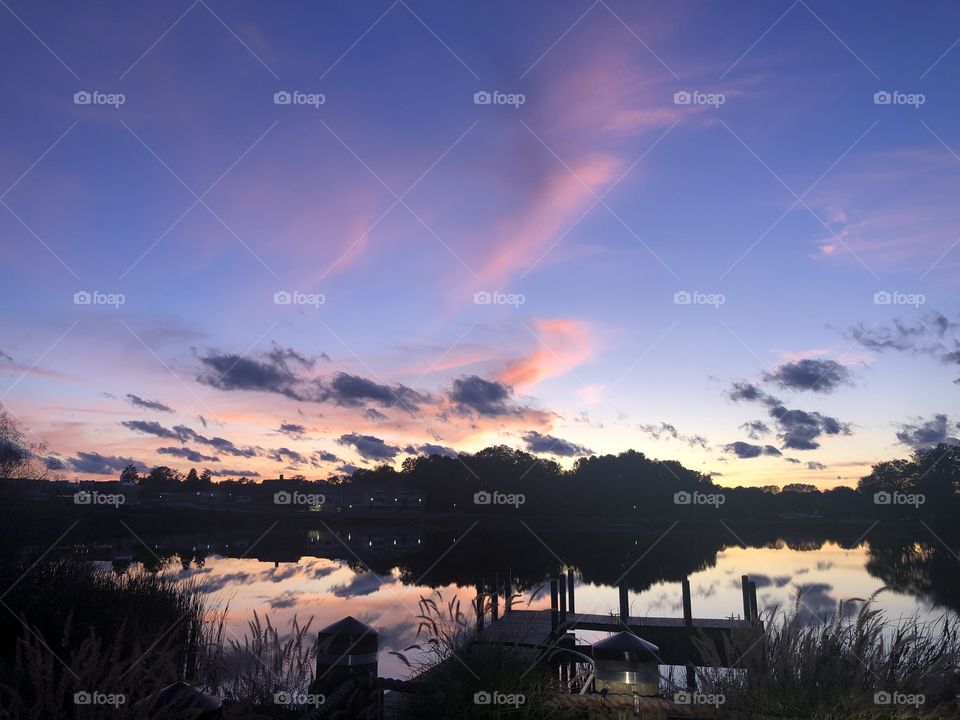Sunset, clouds mirrored in a lake