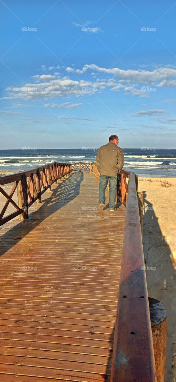 Man walking on the beach walkway