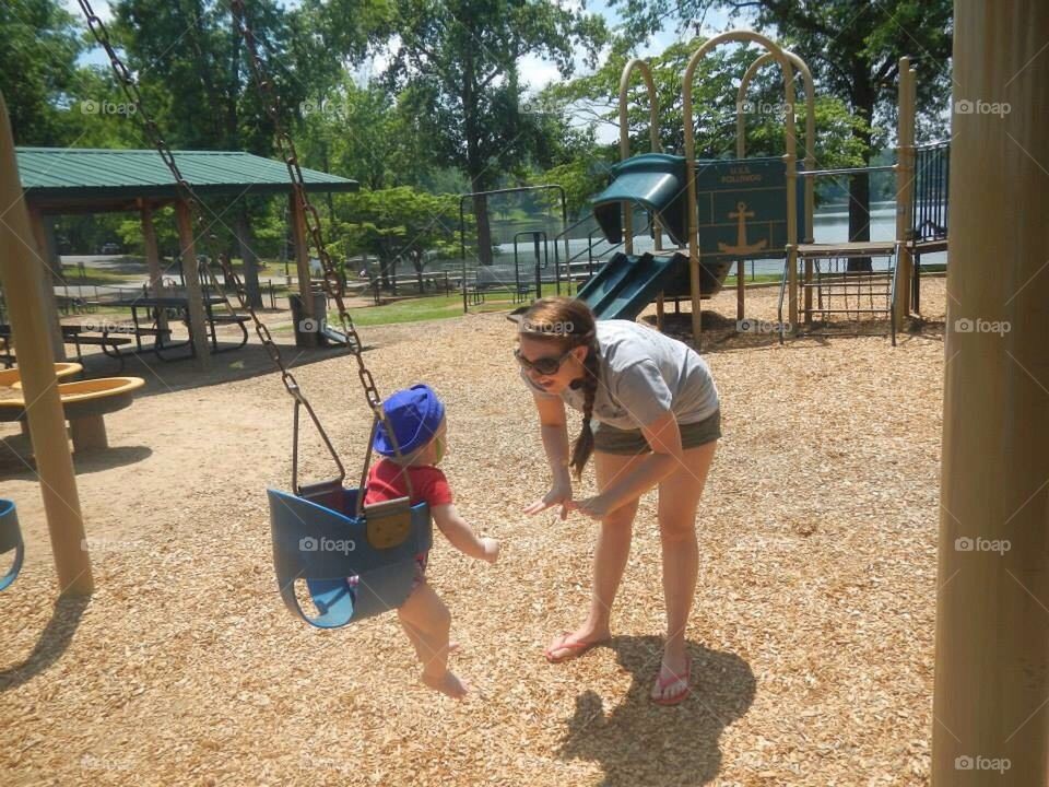 Mommy and son playing at the park