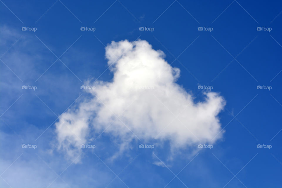 White cloud against blue sky background