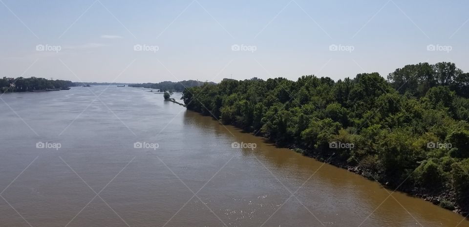 A scene of a river in Arkansas, taken from a bridge.