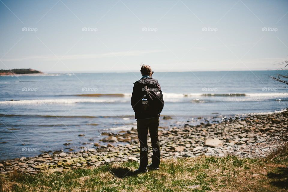 woman standing by the sea