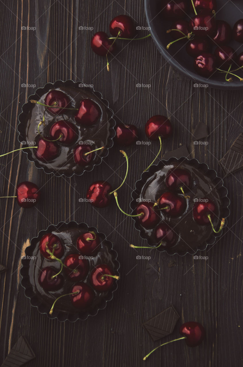 Cooking chocolate tarts with cherries